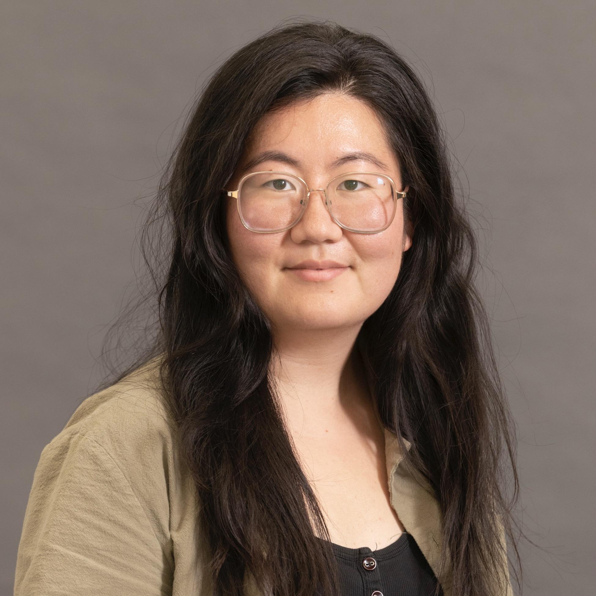 Julia Xia professional headshot. Julia has long dark hair and wears glasses.
